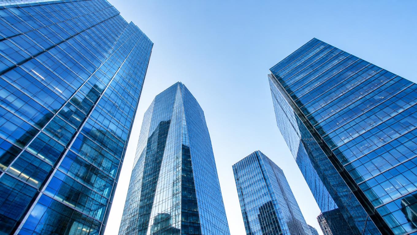 Modern glass corporate towers viewed from below in daylight